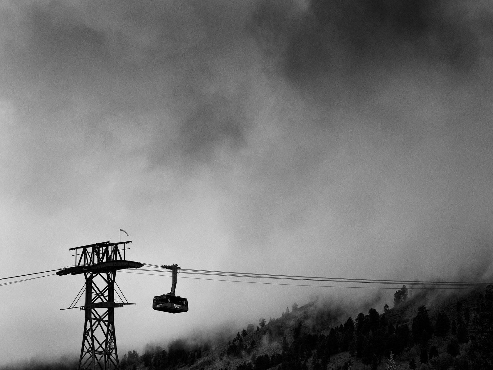 The aerial tram rising into cloud above the valley